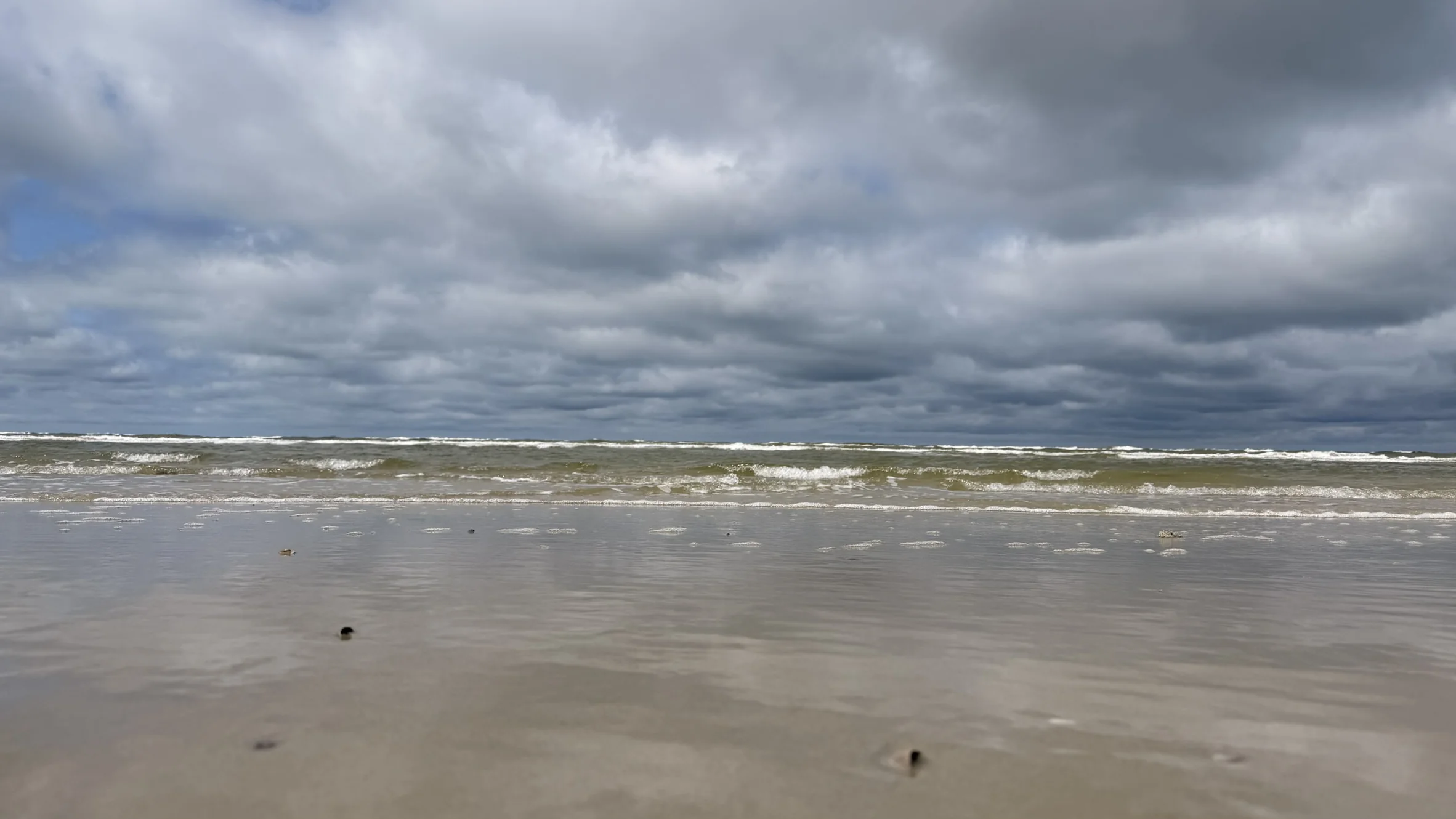 Nordseewellen unter dunklen Wolken